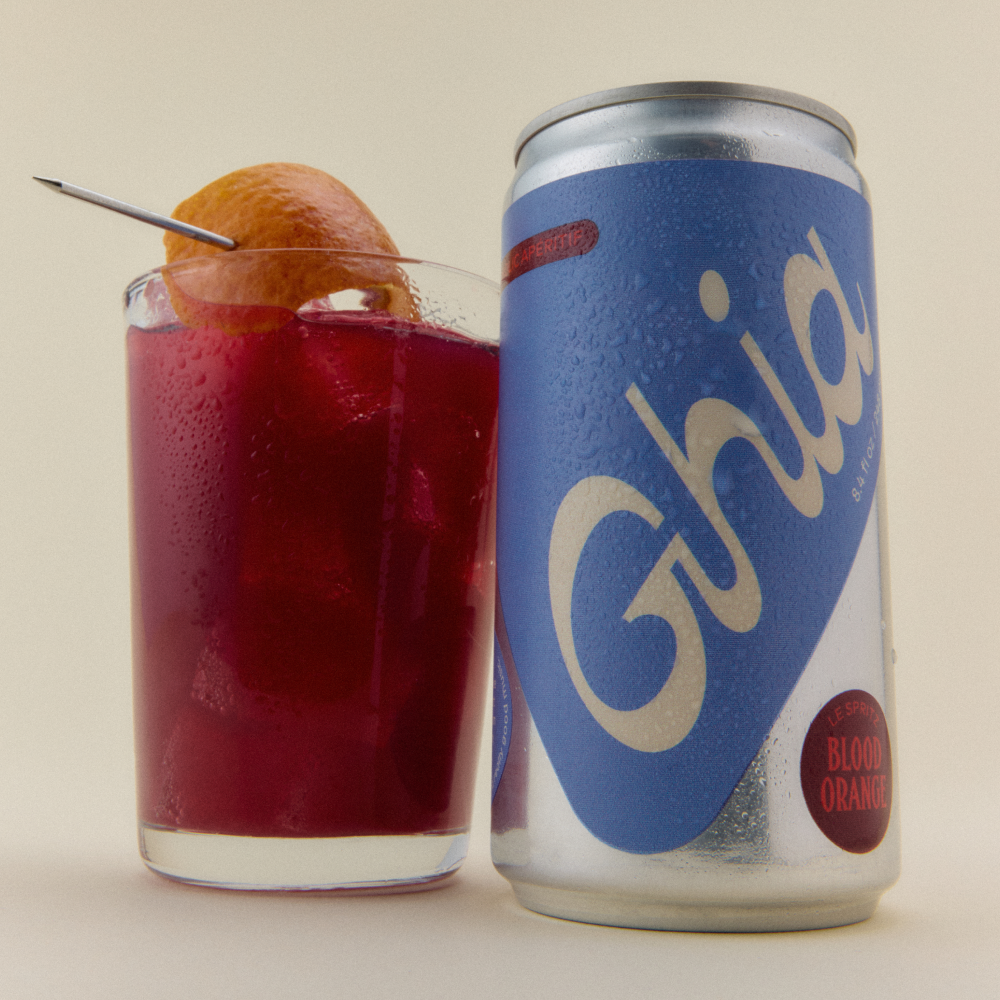 Ghia Le Spritz Blood Orange can beside a glass of spritz